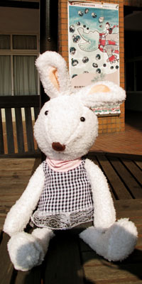 小兔子玩偶坐在幼教系戶外休閒桌椅